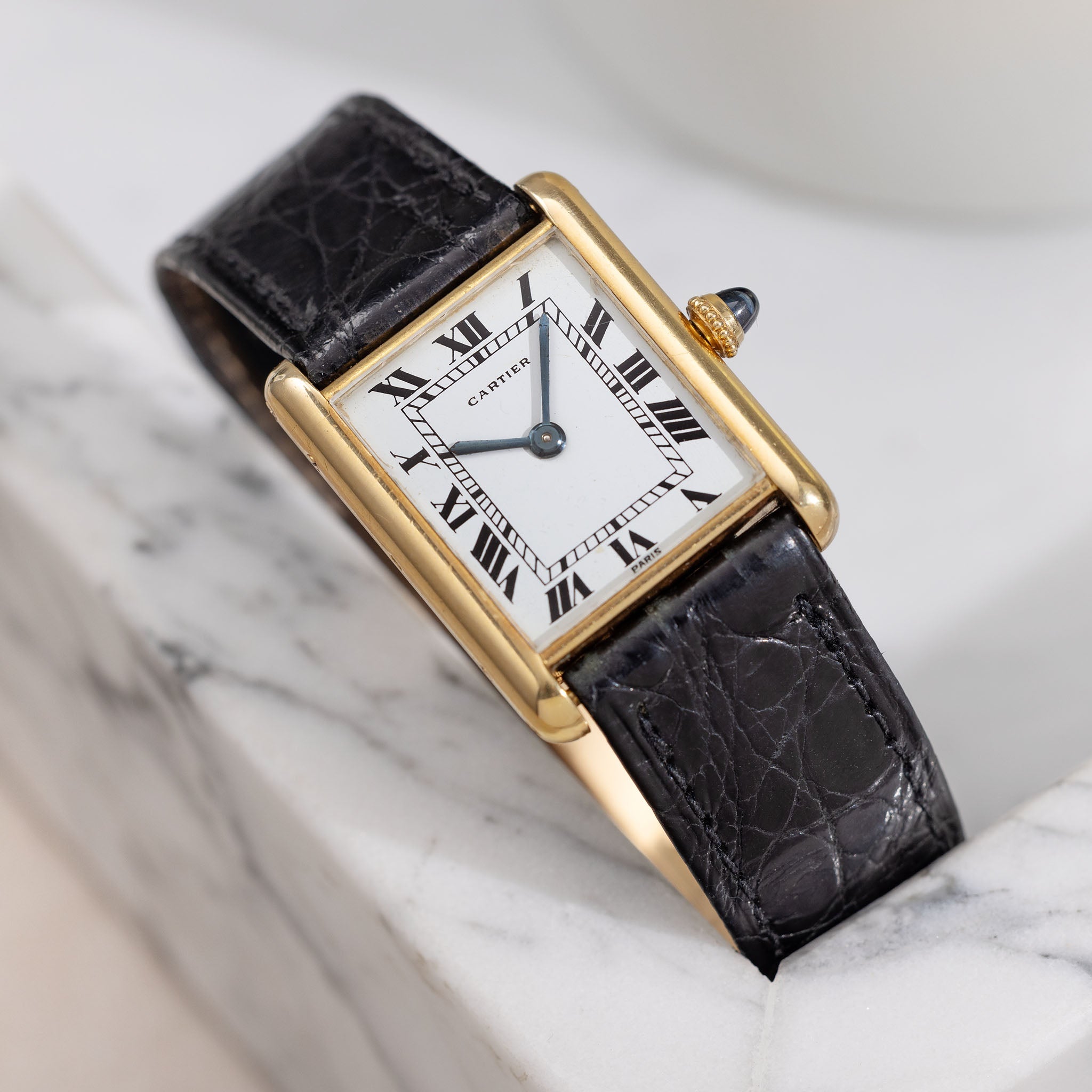 Classic Cartier Tank watch with gold case and Roman numeral dial