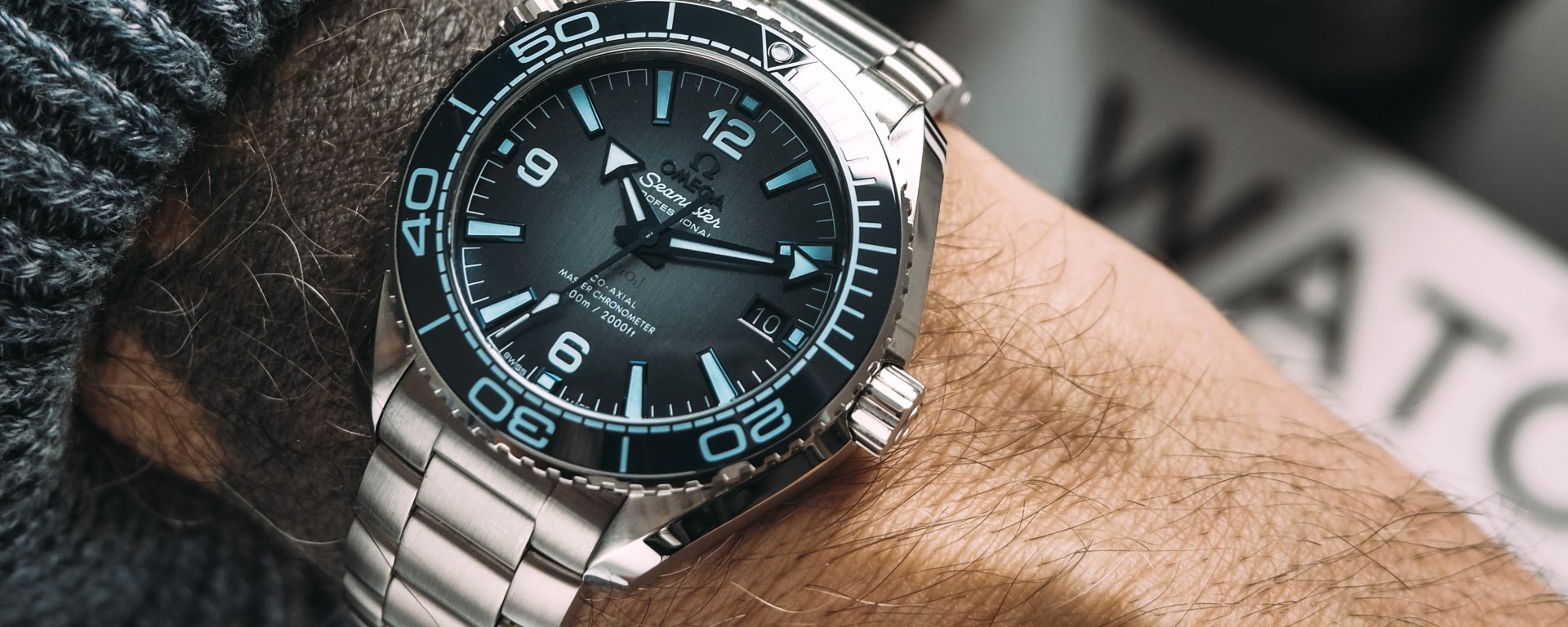 Omega Planet Ocean 600M blue ceramic dial close-up wrist shot