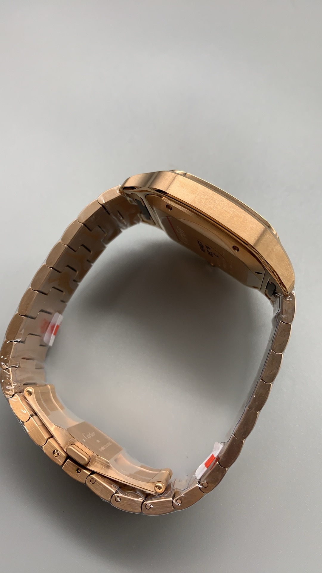 Bracelet closed into a loop, protective film still wrapping the gold links