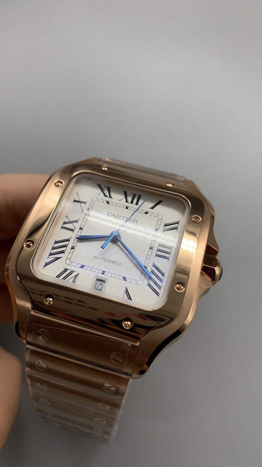 White dial and blued hands framed by the warm rose gold bezel and screws