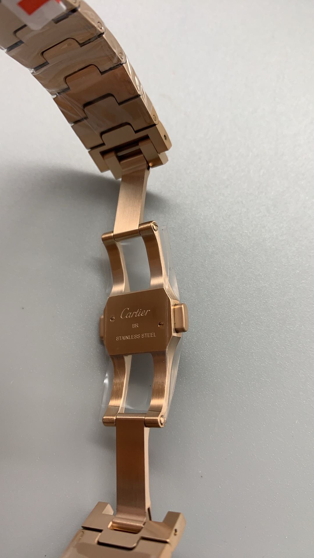 Folding clasp standing open, the Cartier signature engraved on its blade