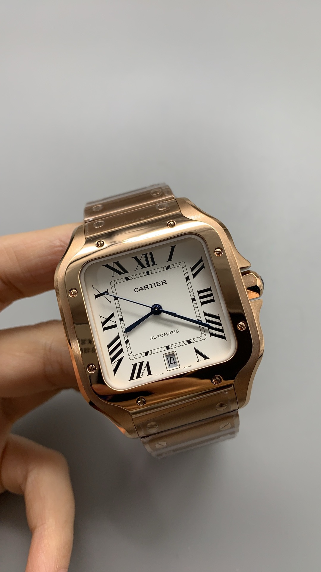 Three-quarter view in the hand, rose gold warming against the white dial