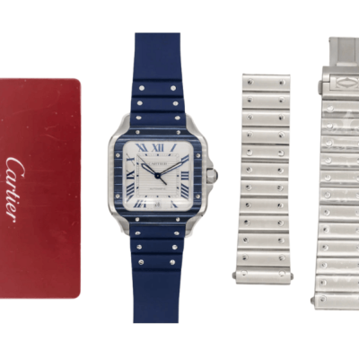 Santos on a blue rubber strap laid out with two spare steel bracelet strands