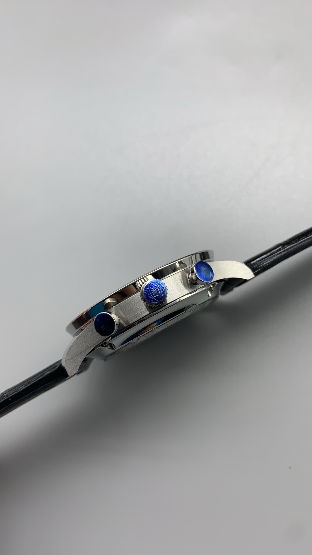 Gold-tone Arabic numerals complete the white dial and blue hand pairing