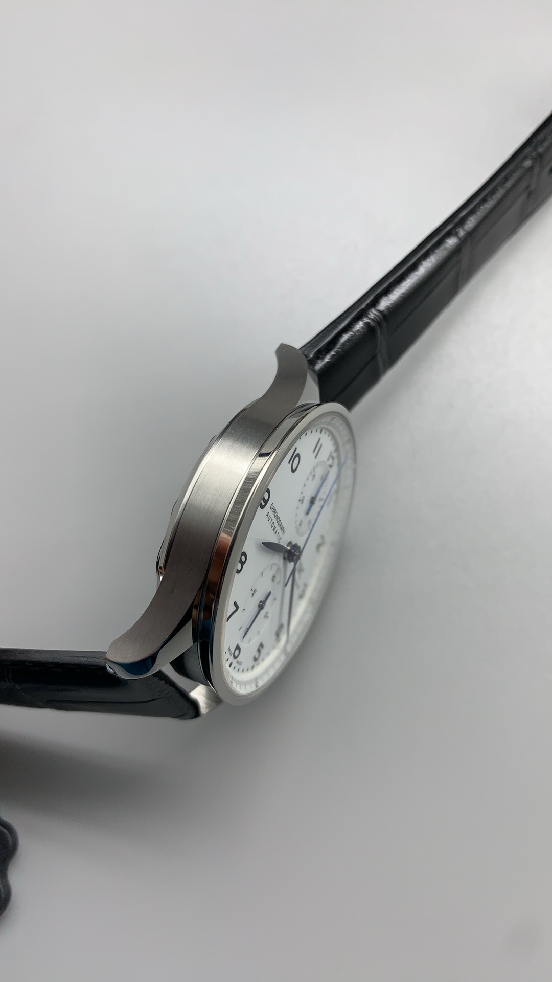 Silver brushing across the subdials, visible under magnification