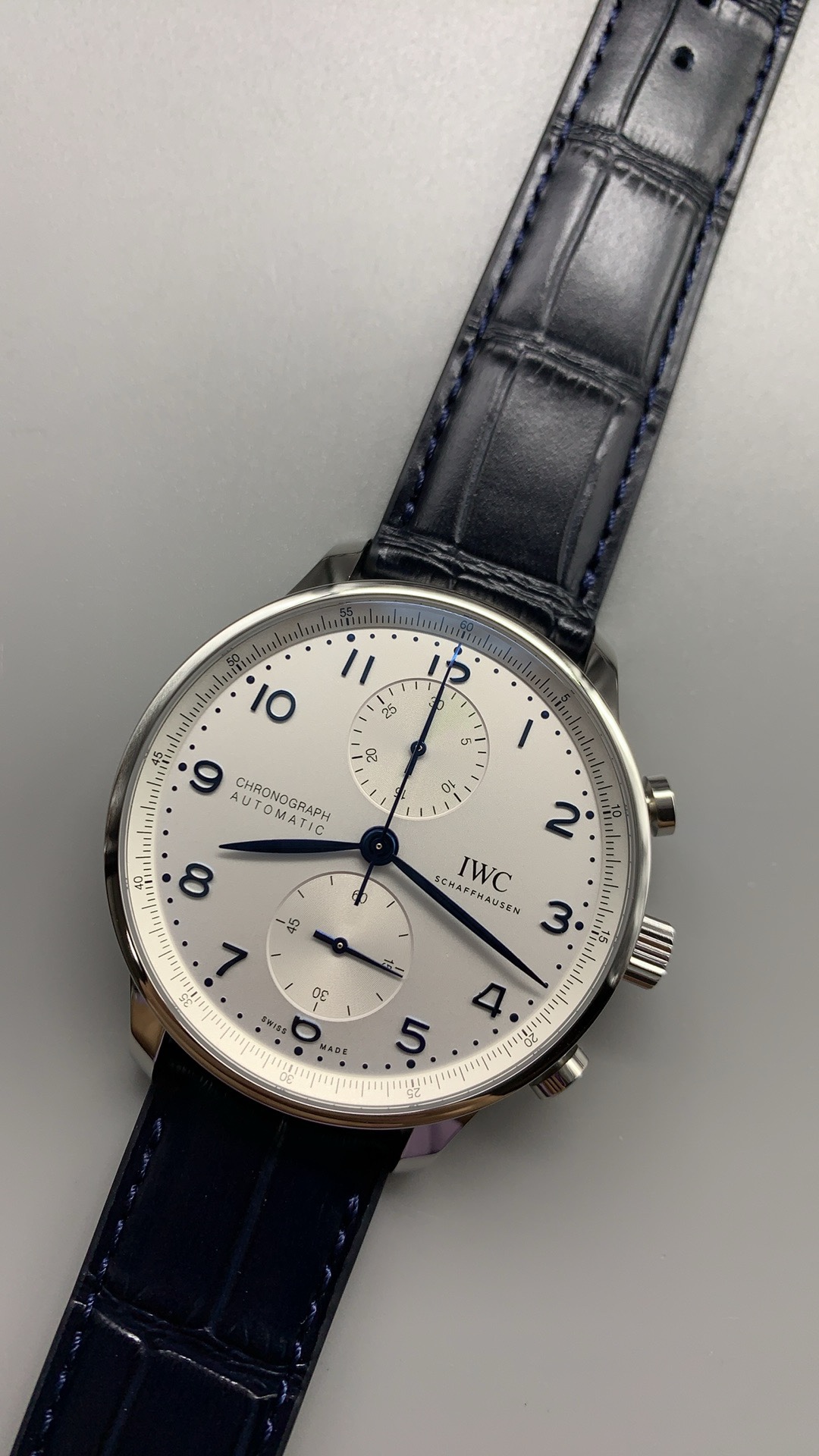 Radial brushing pulls light across the silver surface as the wrist turns