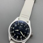 Coated sapphire above matte black, holding glare off a low-contrast dial