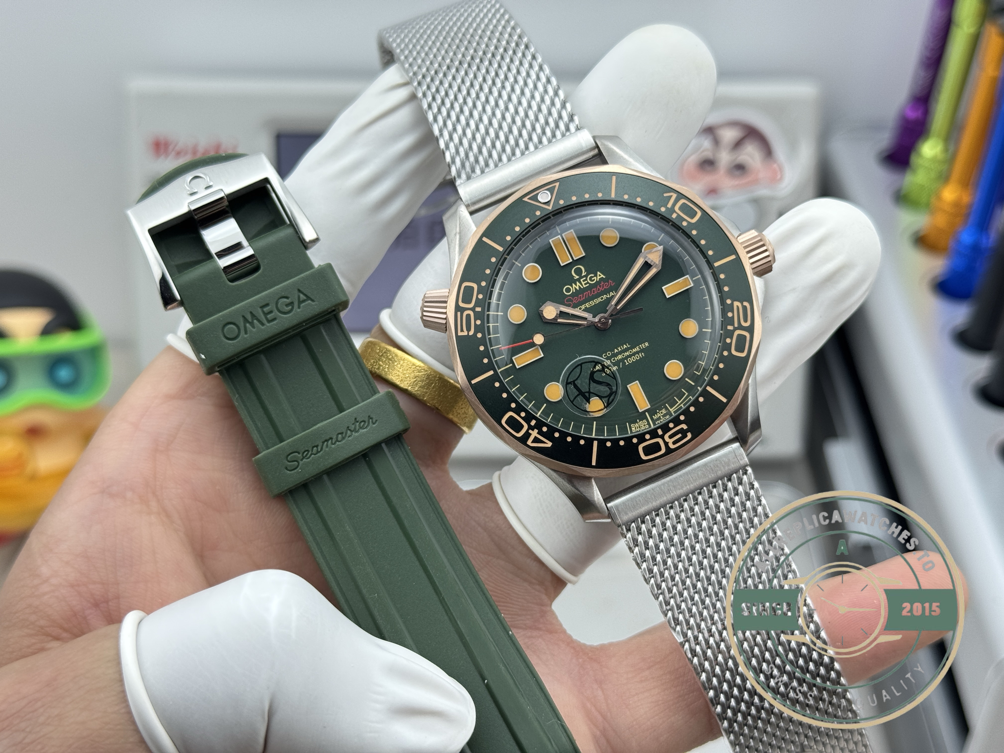 Black ceramic bezel framing the sunburst green dial of this titanium Seamaster clone