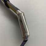 Applied baton hour markers catching side light, with no Arabic numerals on the blue dial