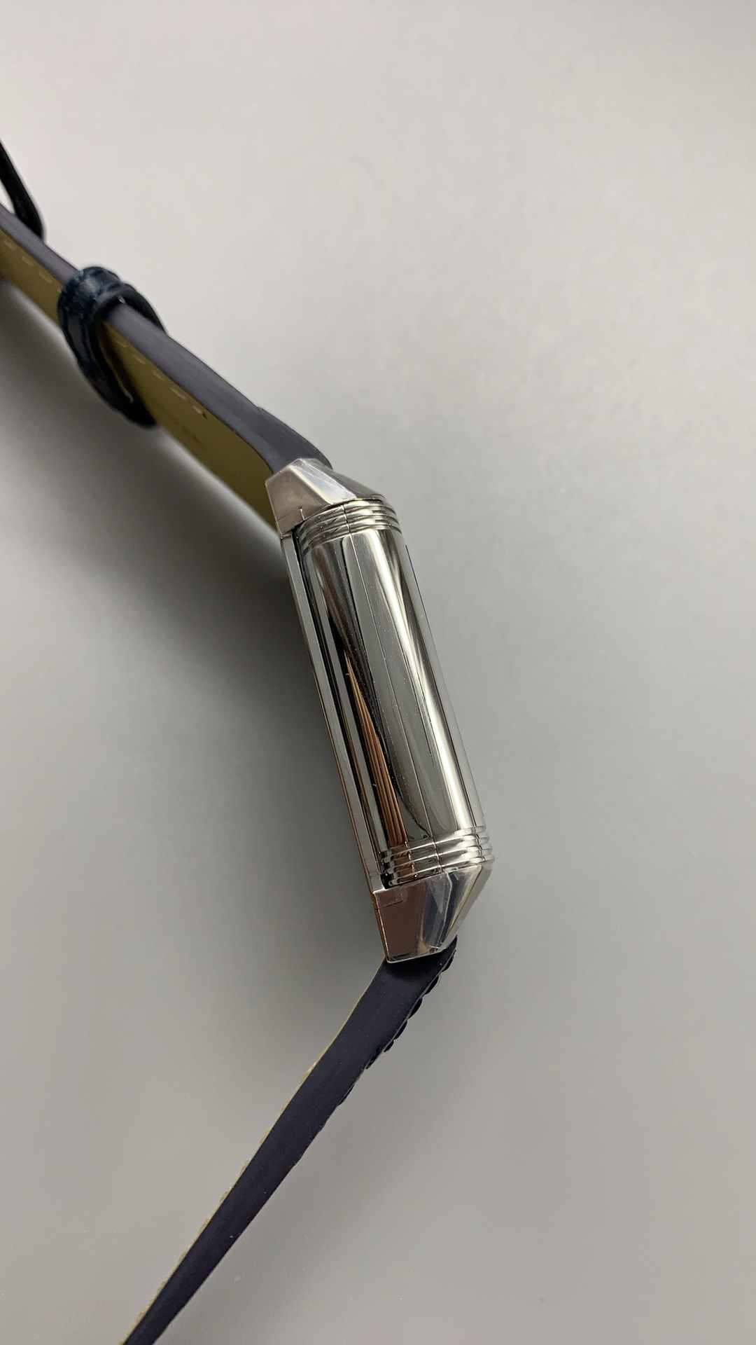 Applied baton hour markers catching side light, with no Arabic numerals on the blue dial