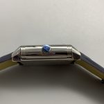 Blue smooth leather strap laid flat, showing its edge stitching and surface finish