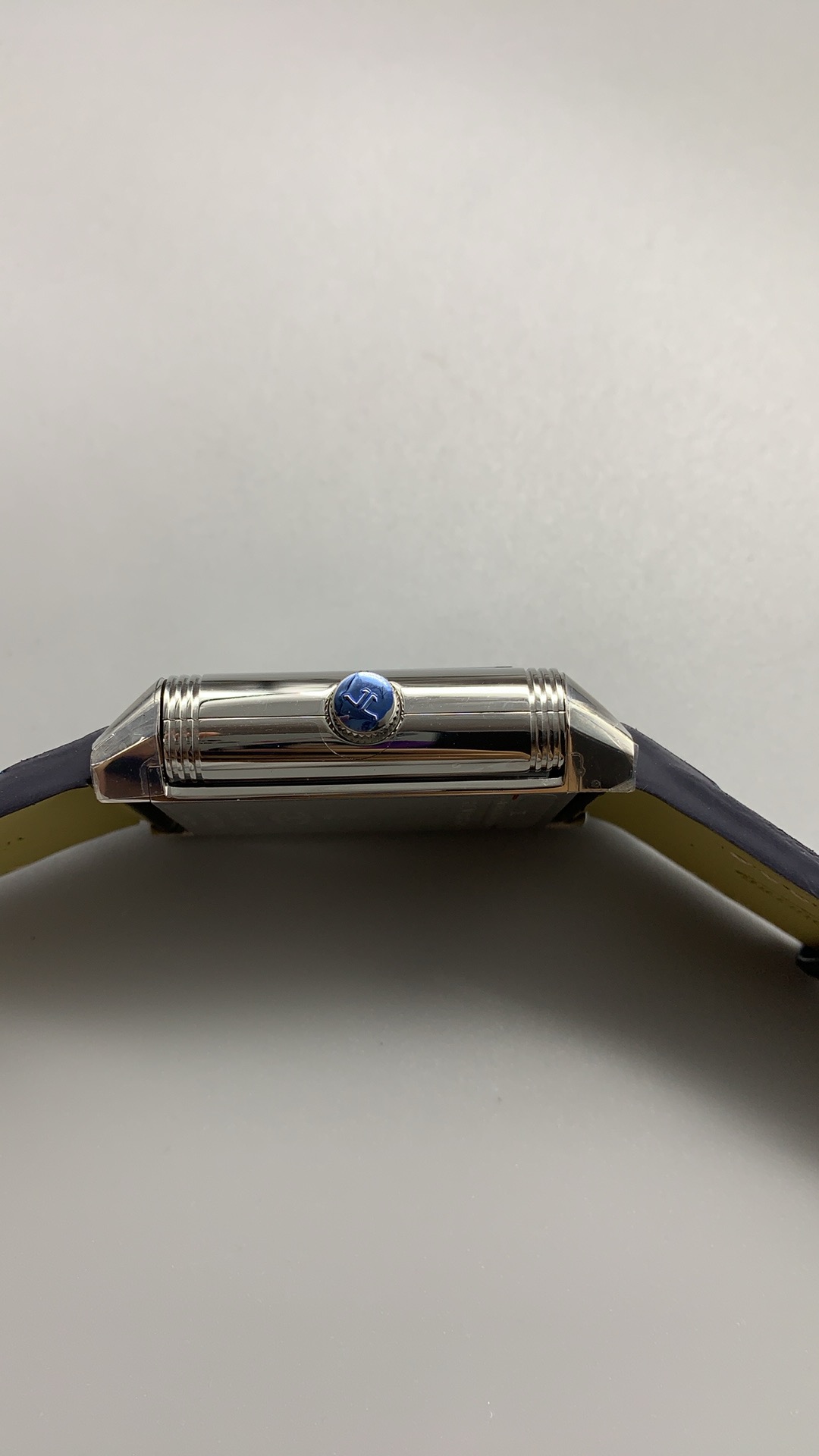 Blue smooth leather strap laid flat, showing its edge stitching and surface finish