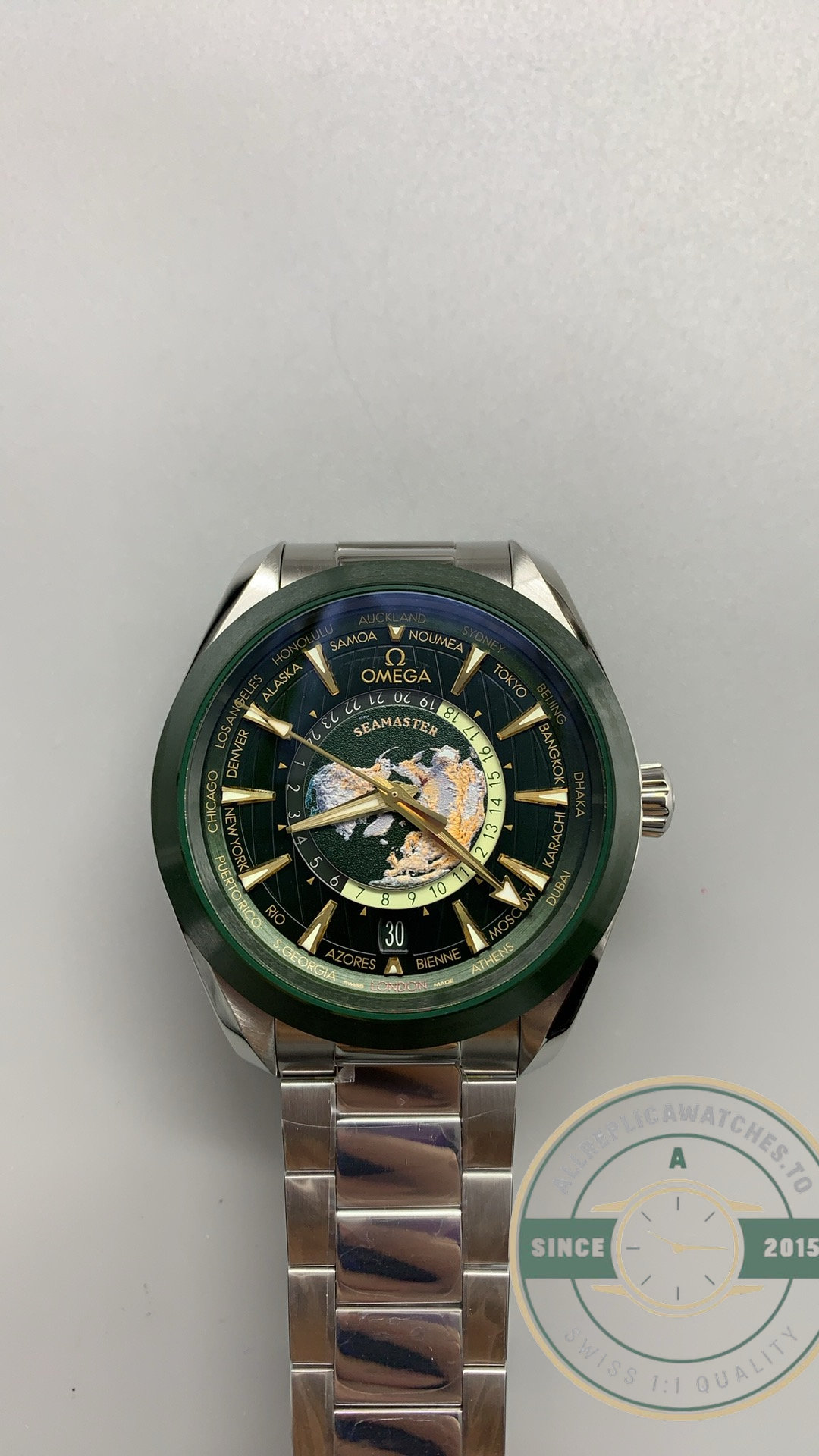 Super clone Omega Aqua Terra Worldtimer date aperture set into the green lacquered surface