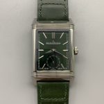 Three-quarter view of the green Reverso Tribute Monoface replica, steel case on green leather