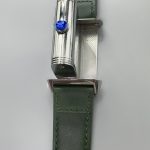Green Reverso dial at an angle, sun-ray finish darkening toward the edges under raking light