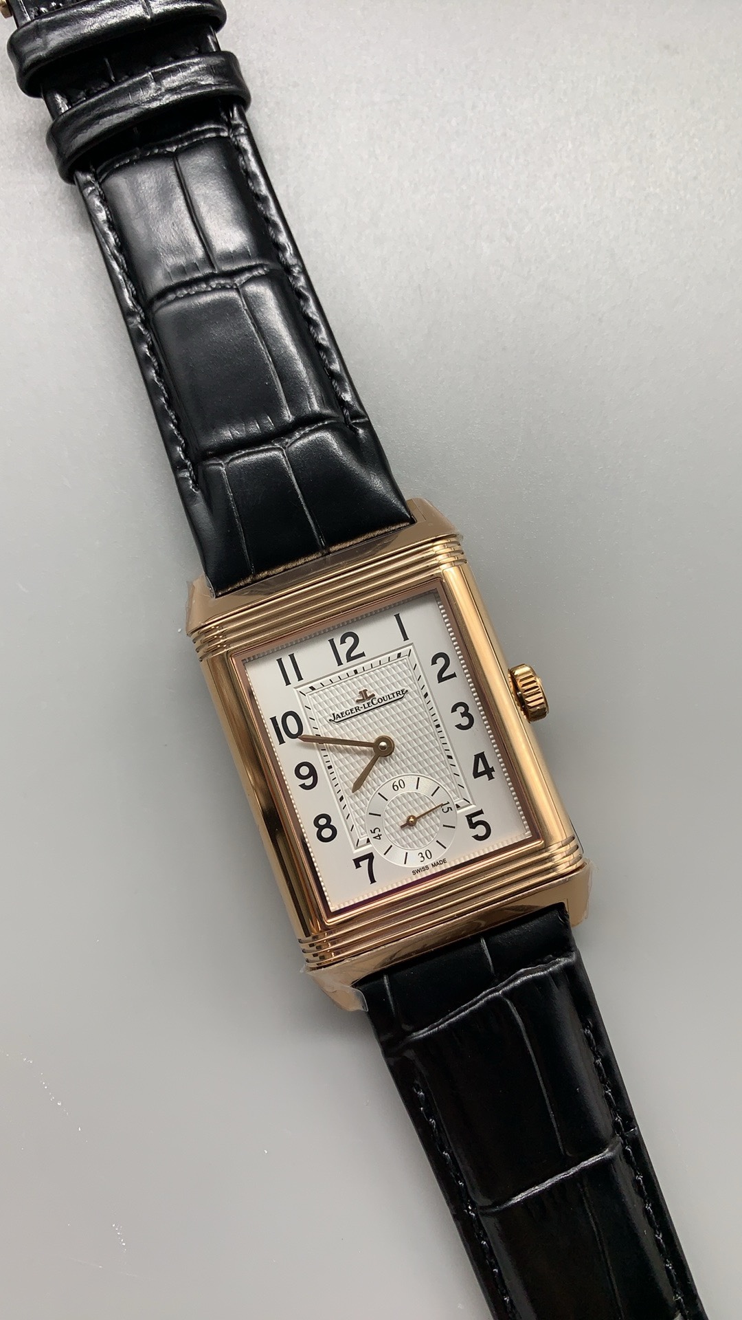 Wrist shot of the rose gold JLC Reverso replica worn with the guilloché dial facing out