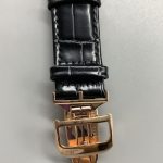 Case locked in its cradle, seen side-on with no gap between frame and rose gold case