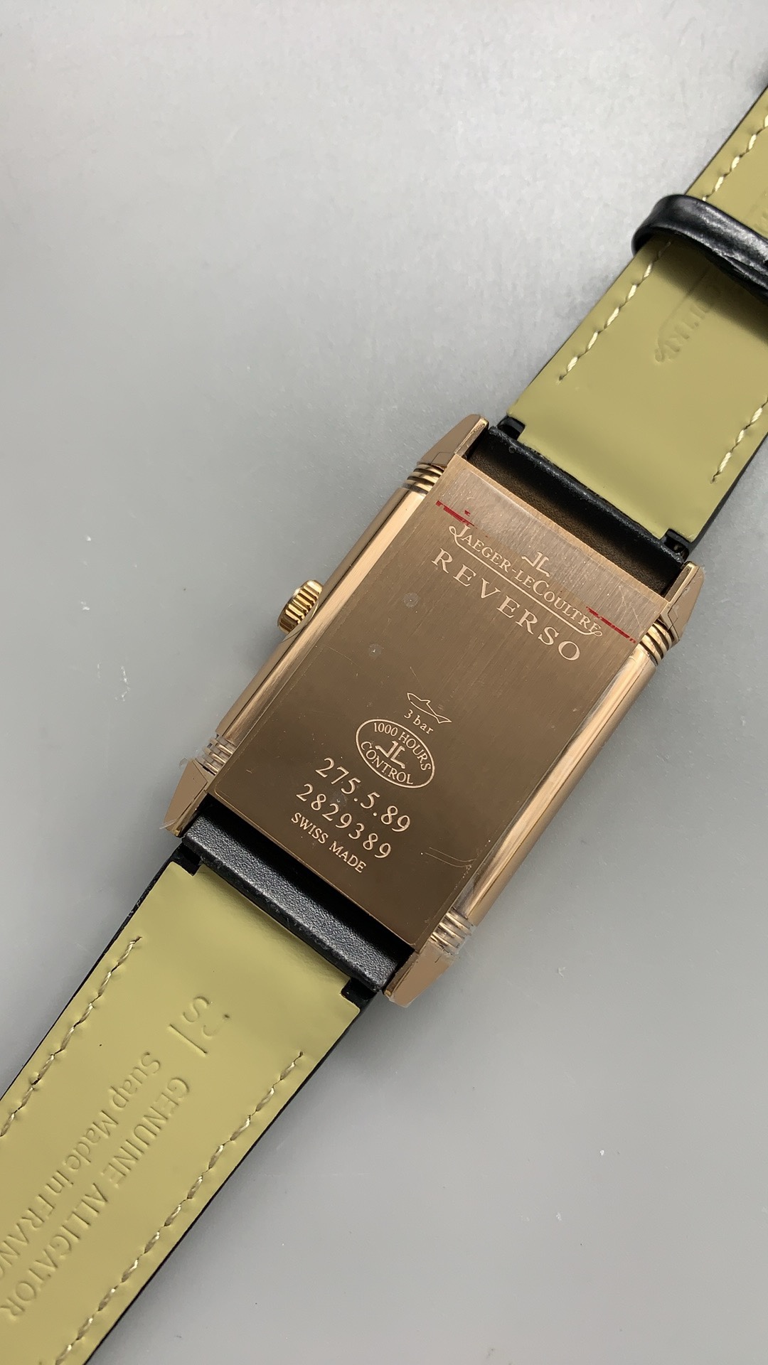 Flat lay of the JLC Reverso Duoface Q3842520 replica with the alligator strap laid open