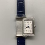 Side profile of the slim rectangular women's case with the blue alligator strap attached