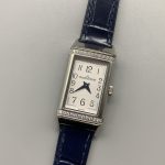 Sapphire crystal viewed at a low angle above the silvered guilloche dial of the Q3288420