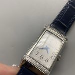 Women's Reverso super clone worn on the wrist, compact rectangular steel case on blue alligator