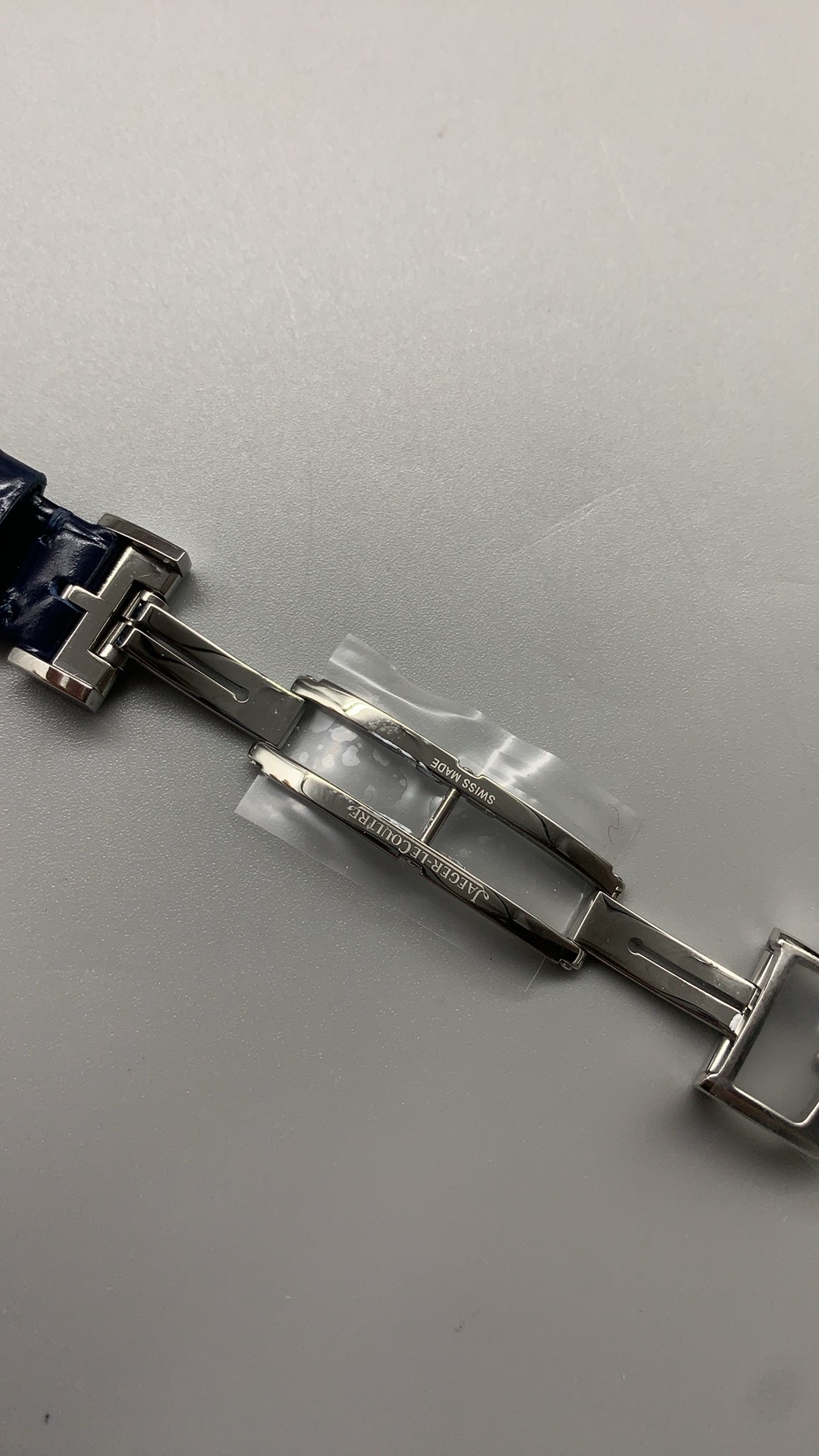 Strap and lug junction of this JLC Reverso replica, blue alligator leather meeting steel