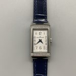 Blue alligator strap scales photographed beside the diamond-set steel cradle of the Reverso