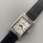 Polished flutes along the edge of the rectangular stainless steel Reverso case frame