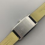 Angled three-quarter shot of the white-dial Reverso showing dial depth and case height