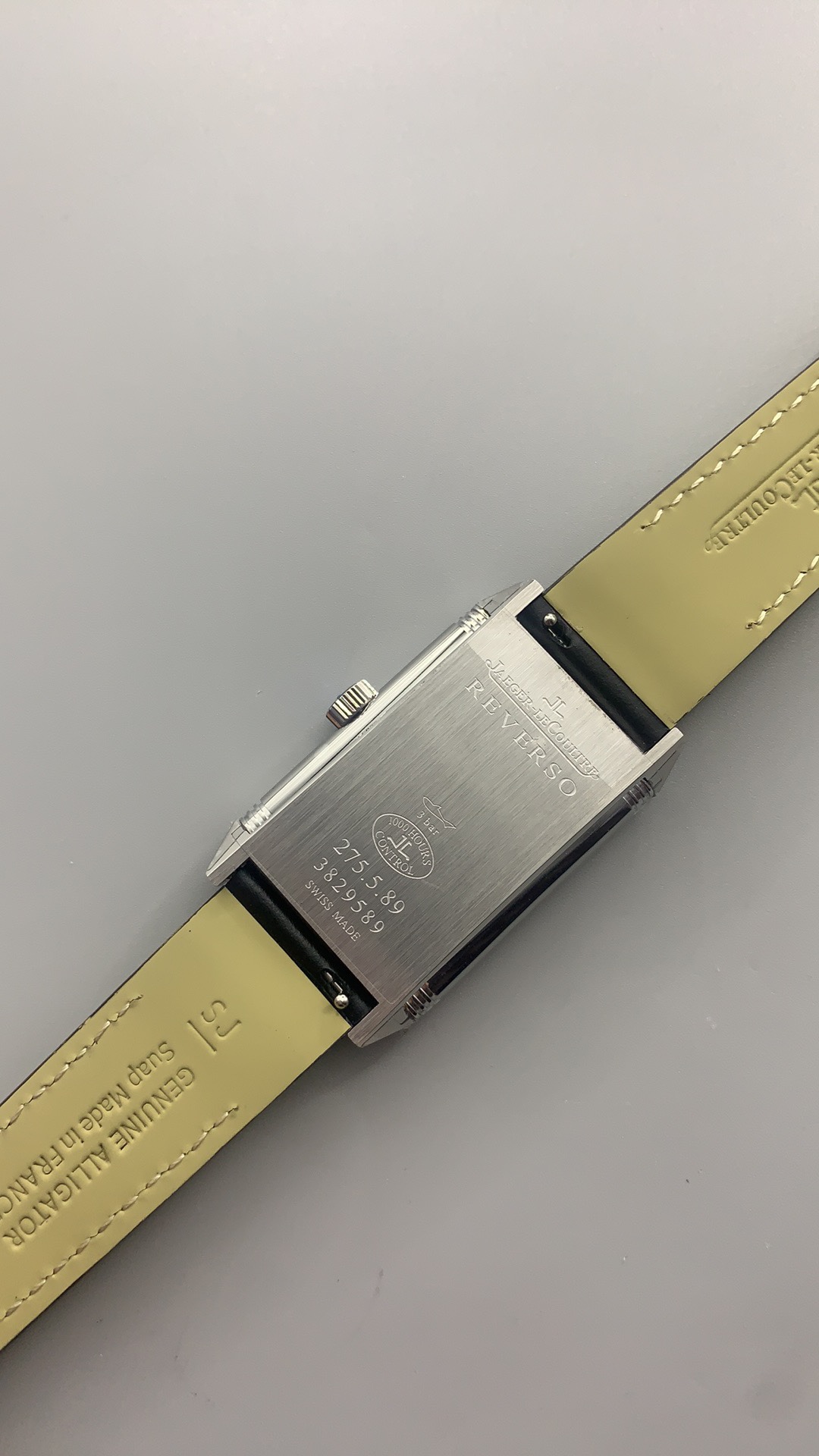 Angled three-quarter shot of the white-dial Reverso showing dial depth and case height