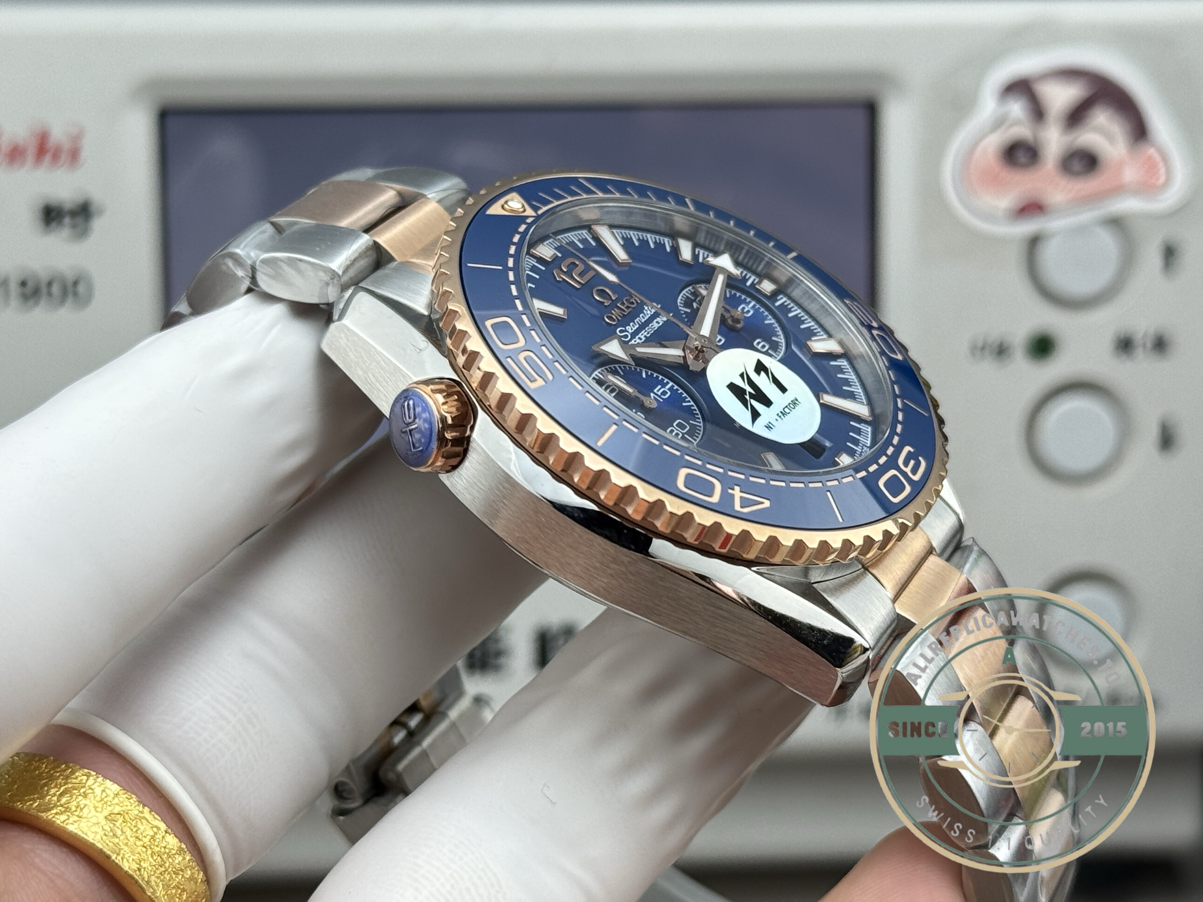 Gold-accented bracelet links on the superclone Omega Planet Ocean 600M chronograph