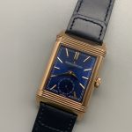 Top-down flat lay of the Q3982590 Duoface replica with the blue leather strap laid out straight