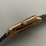 Rose gold Reverso Duoface replica caught mid-turn, case swung out of its rectangular cradle