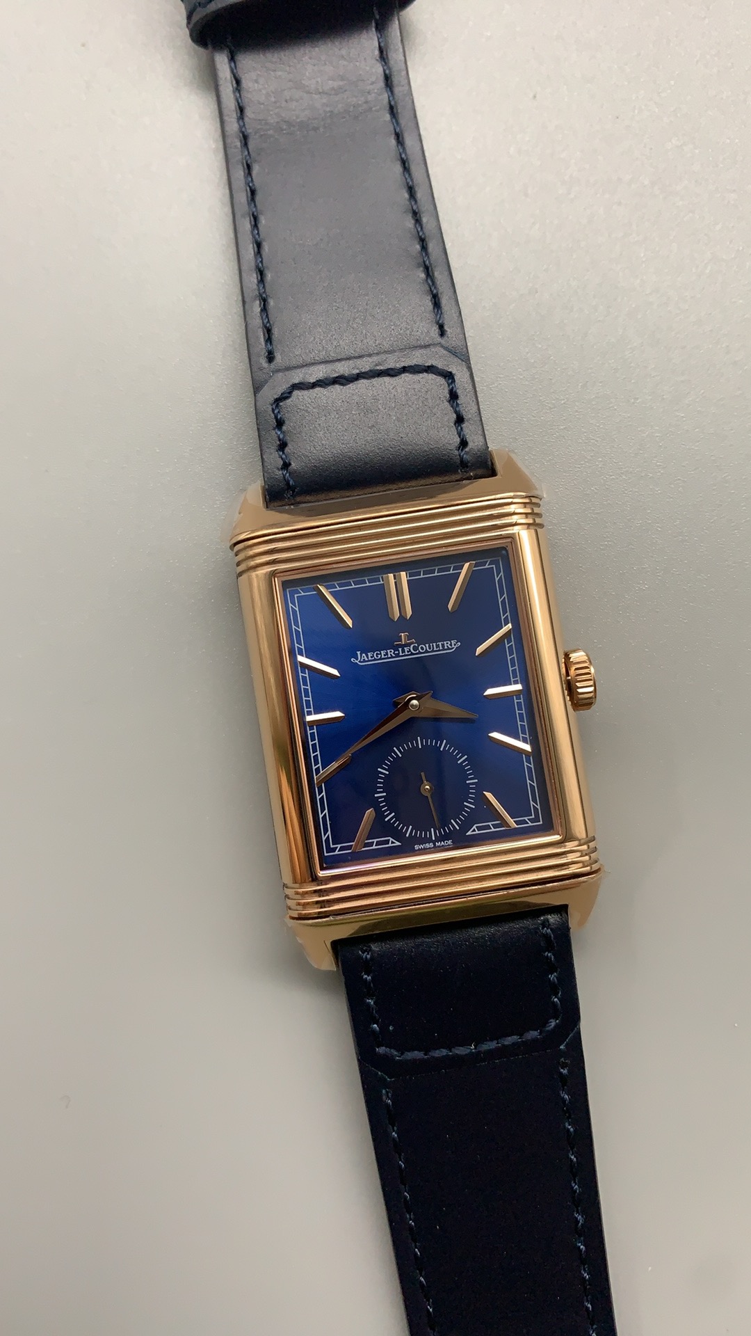 Reverso Tribute Duoface replica worn on the wrist, rectangular rose gold case lying flat